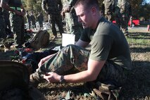 Fatigue starts to set in as Sgt. Michael Gannon, an Extract Marine assigned to React Company with the Chemical Biological Incident Response Force, as he changes into the next uniform after completing a three-mile run in protective MOPP gear and a gas mask. It was the second of three, three-mile runs in the CBIRF Commander’s Challenge on Nov. 6. (Official Marine Corps photo by Sgt. Frances L Goch, Released)