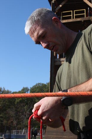 Captain Ronald Briley, Headquarters and Support Company Commander, ties a double fisherman during the knot test in the second phase of the Chemical Biological Incident Response Force Commander’s Challenge on Nov. 6. The challenge to not only tested physical strength and endurance but their knowledge base of CBRNE consequence management as well. (Official Marine Corps photo by Sgt. Frances L Goch, Released)