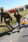 Staff Sgt. Stuart Turnquist motivates Cpl Antwuan Brown as he pulls a casualty sled down the 100 meter stretch during the third and final phase of the Commander’s Challenge on Nov. 6.