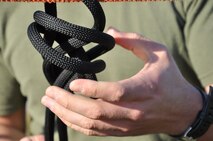 A Marine assigned to the Chemical Biological Incident Response Force ties a rescue knot, figure eight on a bite, during one of the three knot challenges in the Chemical Biological Incident Response Force Commander’s Challenge on Nov. 6.