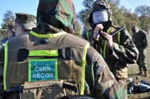 Suiting up: Marines get into their protective MOPP gear and gas masks for the second of three, three-mile runs during the Chemical Biological Incident Response Force Commander’s Challenge on Nov. 6.
