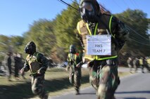 Marines assigned to the Chemical Biological Incident Response Force begin a grueling three-mile run in their protective MOPP gear and gas masks during the second phase of the CBIRF Commander’s Challenge on Nov. 6.