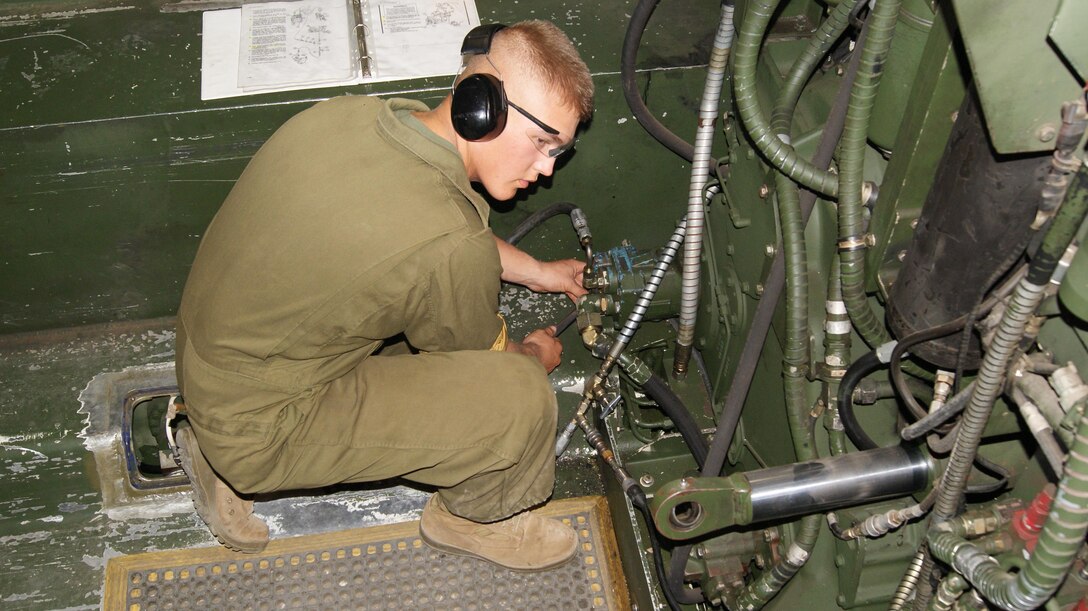 Marine attending the Basic Engineer Equipment Repairers Course performs a diagnostic test on a Hydraulic pump.