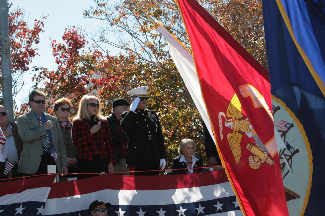 Maj. Gen. Glenn M. Walters, the commanding general of 2nd Marine Aircraft Wing, salutes the colors as they pass by at the Carteret County Veterans Day parade in Morehead City, N.C., Nov. 10. Walters served as the parade's Grand Marshall.