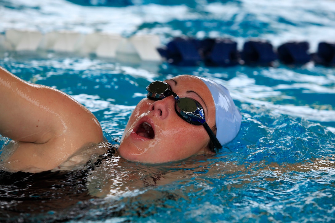Tara A. Bright, a program manager for the Warrior Athlete Reconditioning Program (WARP), swims during the Total Athlete Training Camp at the Hope and Care Center Lap Pool here Nov. 15.