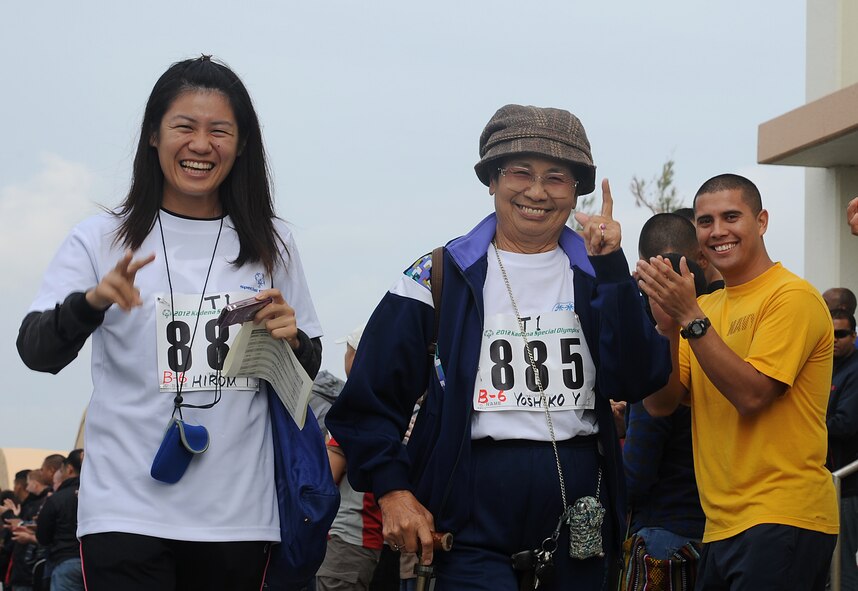 Yoshiko Yonamine, Kadena Special Olympics participant, is welcomed during the opening ceremonies of the 13th annual KSO on Kadena Air Base, Japan, Nov. 17, 2012. More than 5,000 people attended KSO festivities including nearly 1,000 American volunteers and 500 local national interpreters, along with senior officials from the Government of Japan, Okinawa Prefectural Government, local communities and the U.S. military. (U.S. Air Force photo/Staff Sgt. Laszlo Babocsi)