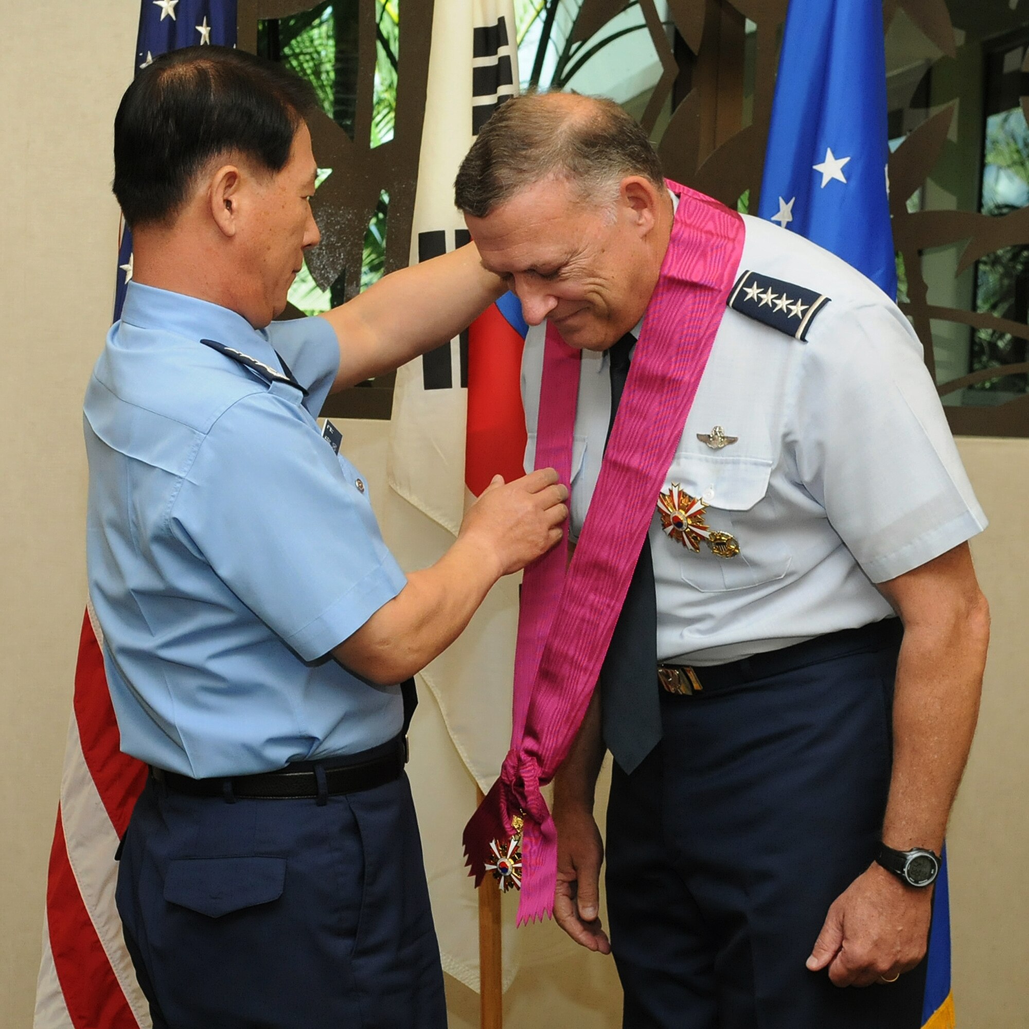 Lt. Gen. Cha-Kyu Choi, Republic of Korea, Air Force Vice Chief of Staff, presents retired Gen. Gary North, former Pacific Air Forces commander, with the National Security Merit Tongil Medal at the DePonte Suite, Headquarters PACAF, Joint Base Pearl Harbor-Hickam, Hawaii, Nov. 9, 2012. North received South Korea‘s highest award for foreigners for his tireless efforts to promote security on the peninsula. (U.S. Air Force photo/David Underwood/Released)