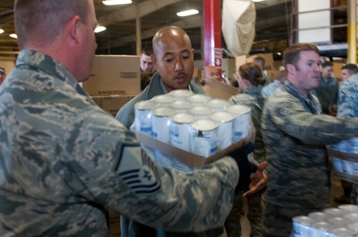 Master Sgt. Matthew Gouveia, U.S. Air Force Warfare Center first sergeant (center) directs Airmen volunteering to help with Operation Warm Heart Nov. 13, 2012, at Nellis Air Force Base, Nev. Operation Warm Heart is funded by the Tug Boat association and run by the First Sergeants association. This year the operation donated 700 Thanksgiving meals. (U.S. Air Force photo by Senior Airman Jack Sanders)
