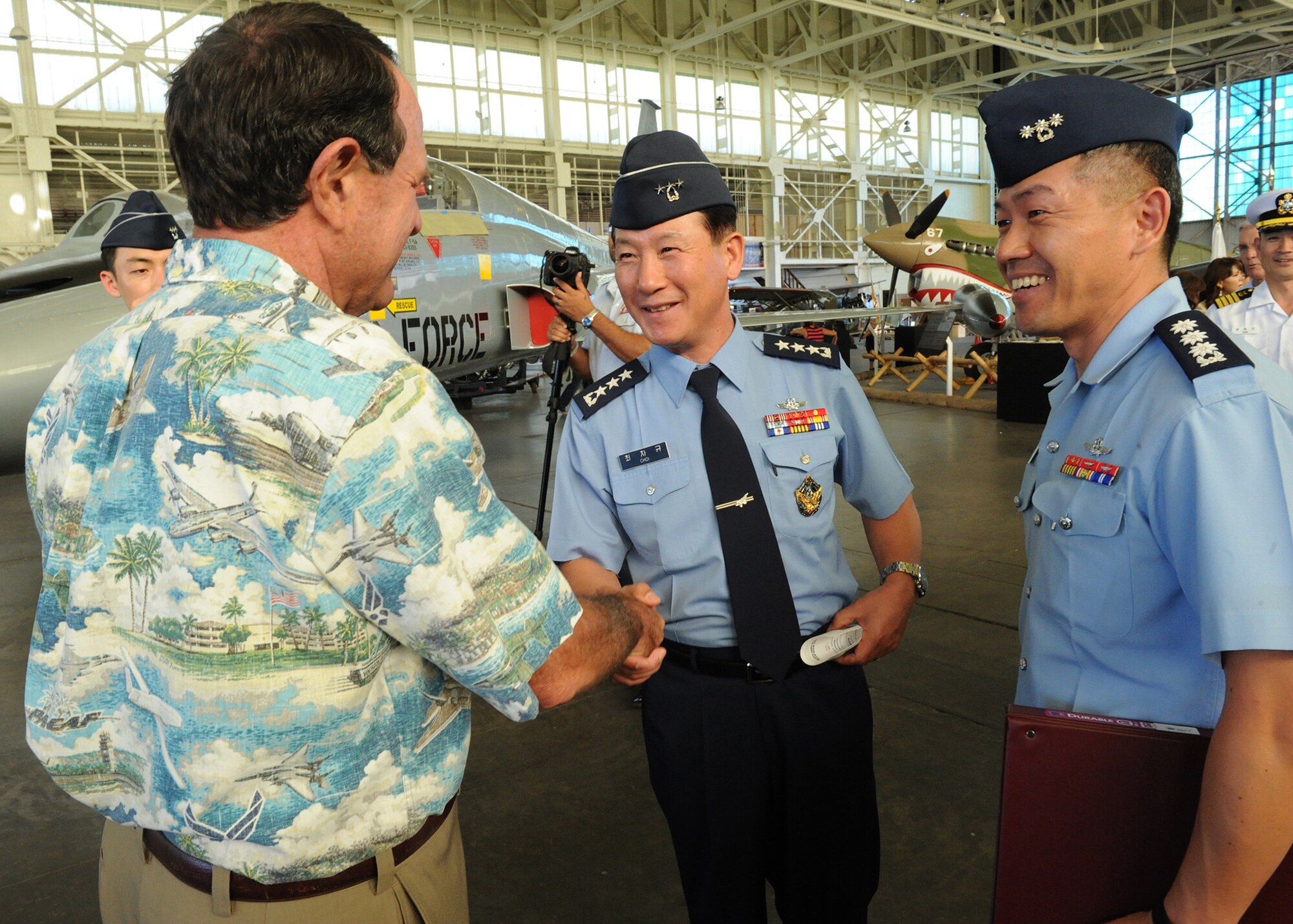 Lt. Gen. Cha-Kyu Choi, Republic of Korea, Air Force Vice Chief of Staff, and his aide Capt. Seung Min Ok are welcomed by Clint Churchill, Pacific Aviation Museum Board President, at Ford Island, Hawaii, Nov. 12, 2012.  Choi visited the museum to help dedicate a ROKAF F-5A Freedom Fighter to Gen. Kim Too Man, a legendary ROKAF figure. (U.S. Air Force photo/Tech Sgt. Jerome S. Tayborn/Released)