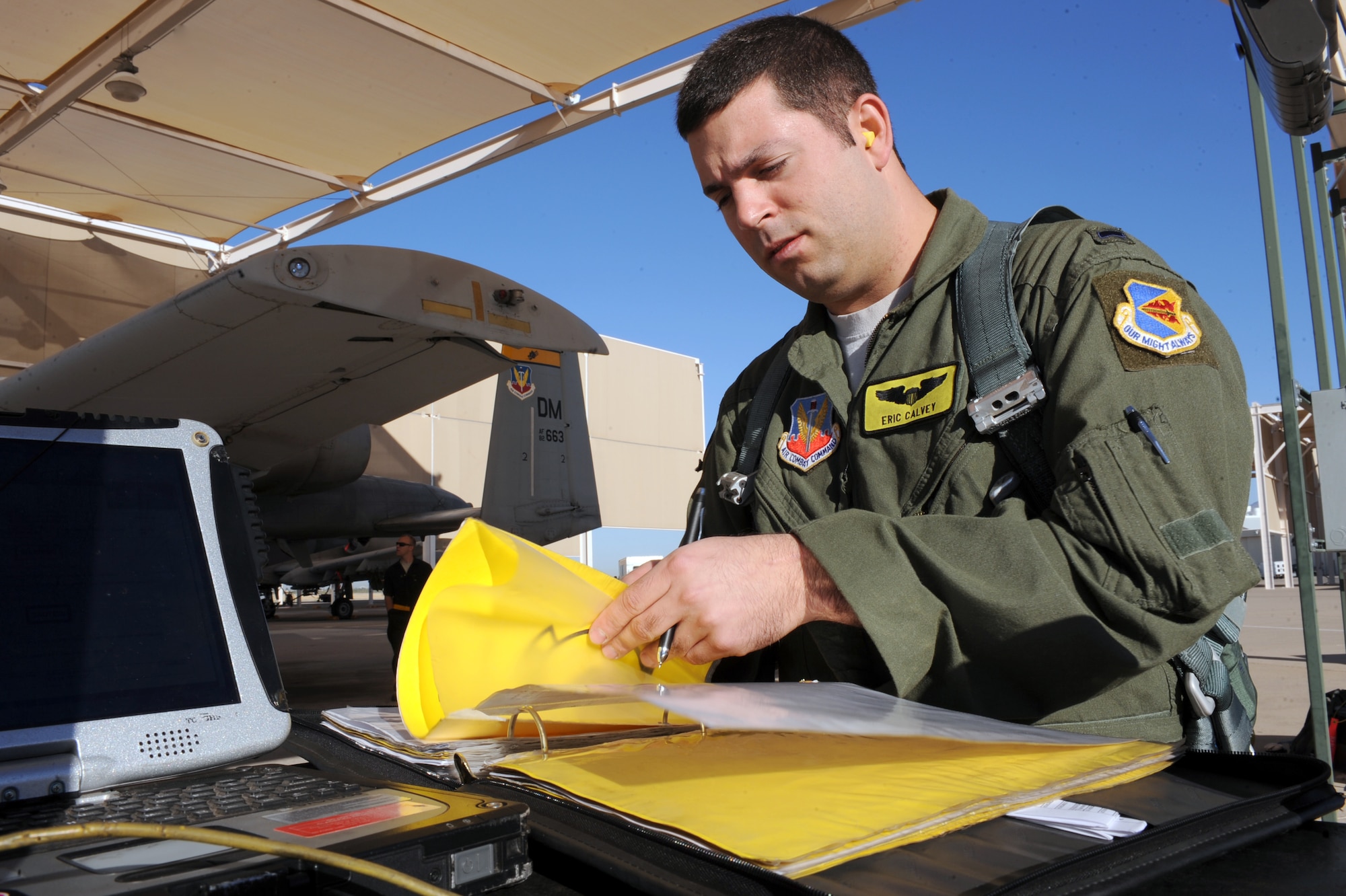 U.S. Air Force 1st Lt. Eric Calvey, 357th Fighter Squadron, reviews maintenance records of the A-10 on Davis-Monthan Air Force Base, Ariz., Nov. 7, 2012. The first step in the pilot's pre-flight checklist is to review the aircraft's maintenance records.  (U.S. Air Force photo by Airman 1st Class Christine Griffiths/Released) 