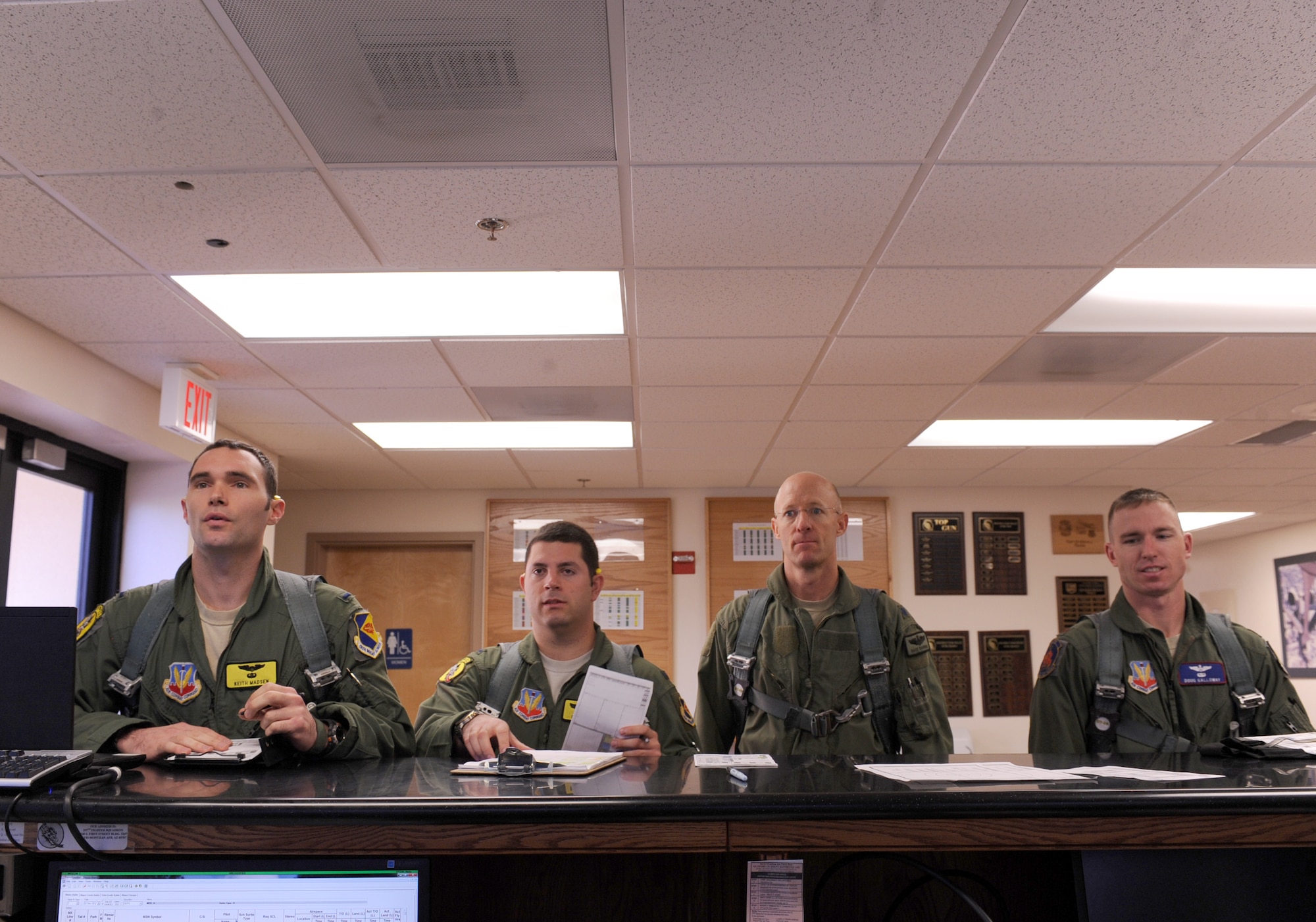 U.S Air Force Airmen from the 357th Fighter Squadron perform their step brief prior to leaving for the flightline on Davis-Monthan Air Force Base, Ariz., Nov. 7, 2012. The step brief consists of finding which aircraft the pilot will fly, what the weather may be like while flying as well as things the pilot must check before departing. (U.S Air Force photo by Airman 1st Class Christine Griffiths/Released) 