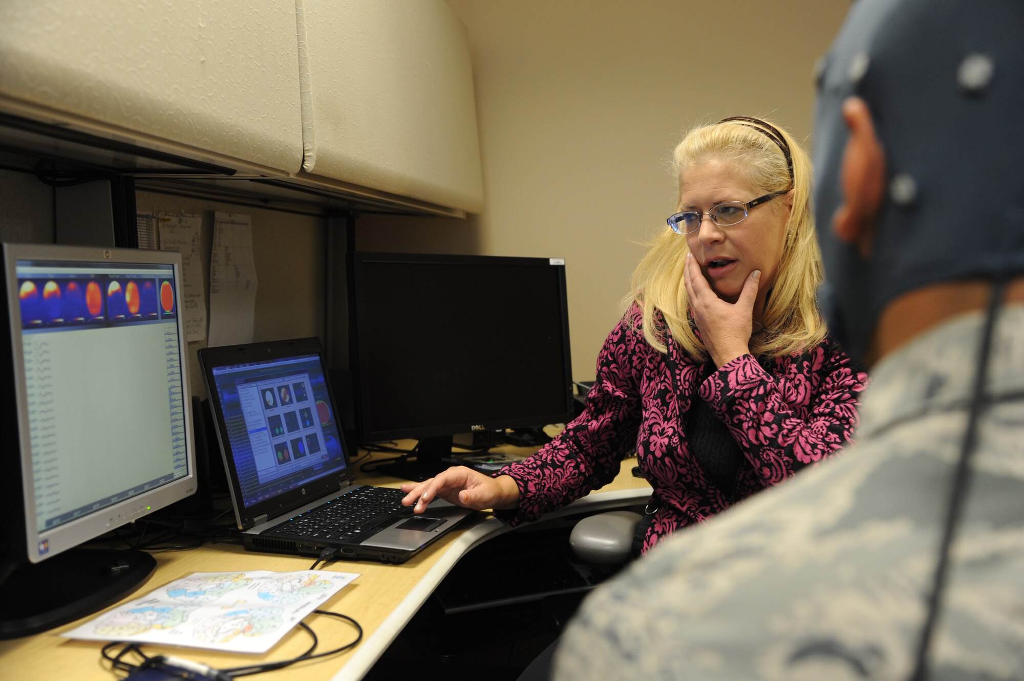 JOINT BASE ANDREWS, Md. - Dr. Beth Davis,779 Medical Operations Squadron deployment behavioral health psychiatrist at Malcolm Grow Medical Clinic, reviews the brain scan of a patient, Nov. 16, 2012. The scan enables patients to see a graphical representation that reacts directly to their thoughts. (U.S. Air Force photo/Airman 1st Class Aaron Stout)