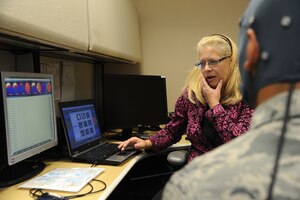 JOINT BASE ANDREWS, Md. - Dr. Beth Davis,779 Medical Operations Squadron deployment behavioral health psychiatrist at Malcolm Grow Medical Clinic, reviews the brain scan of a patient, Nov. 16, 2012. The scan enables patients to see a graphical representation that reacts directly to their thoughts. (U.S. Air Force photo/Airman 1st Class Aaron Stout)