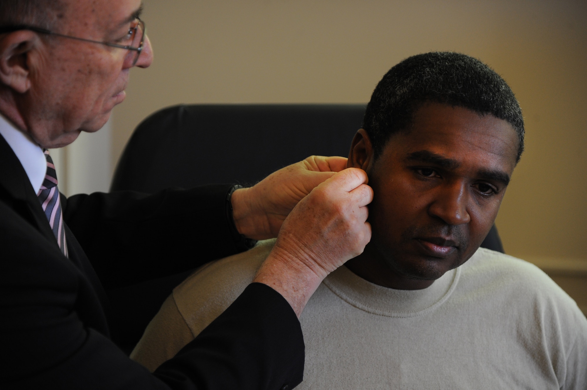 JOINT BASE ANDREWS, Md. - Dr. Richard Niemtzow,779 Medical Operations Squadron chief of acupuncture at Malcolm Grow Medical Clinic, performs Battle Field Acupuncture on Master Sgt. Elie Bellevue, patient, Nov. 16, 2012. According to Niemtzow, the procedure was nearly painless and has an 80 percent success rate in its clinical trials. (U.S. Air Force photo/Airman 1st Class Aaron Stout)