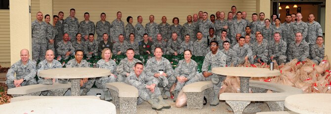 First sergeants and volunteers pose with 242 bags of food and turkeys after sorting them for delivery to Airmen, Nov. 16, 2012, at Beale Air Force Base, Calif. Beale's first sergeants partnered with more than 35 volunteers to assemble 242 bags of food as part of Operation Warm Heart. (U.S. Air Force photo by Senior Airman Shawn Nickel/Released)