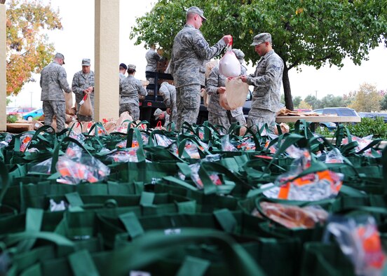 Volunteers pack food to be delivered to Airmen for Thanksgiving, Nov. 16, 2012, at Beale Air Force Base, Calif. Beale's first sergeants partnered with more than 35 volunteers to assemble 242 bags of food as part of Operation Warm Heart. (U.S. Air Force photo by Senior Airman Shawn Nickel/Released)