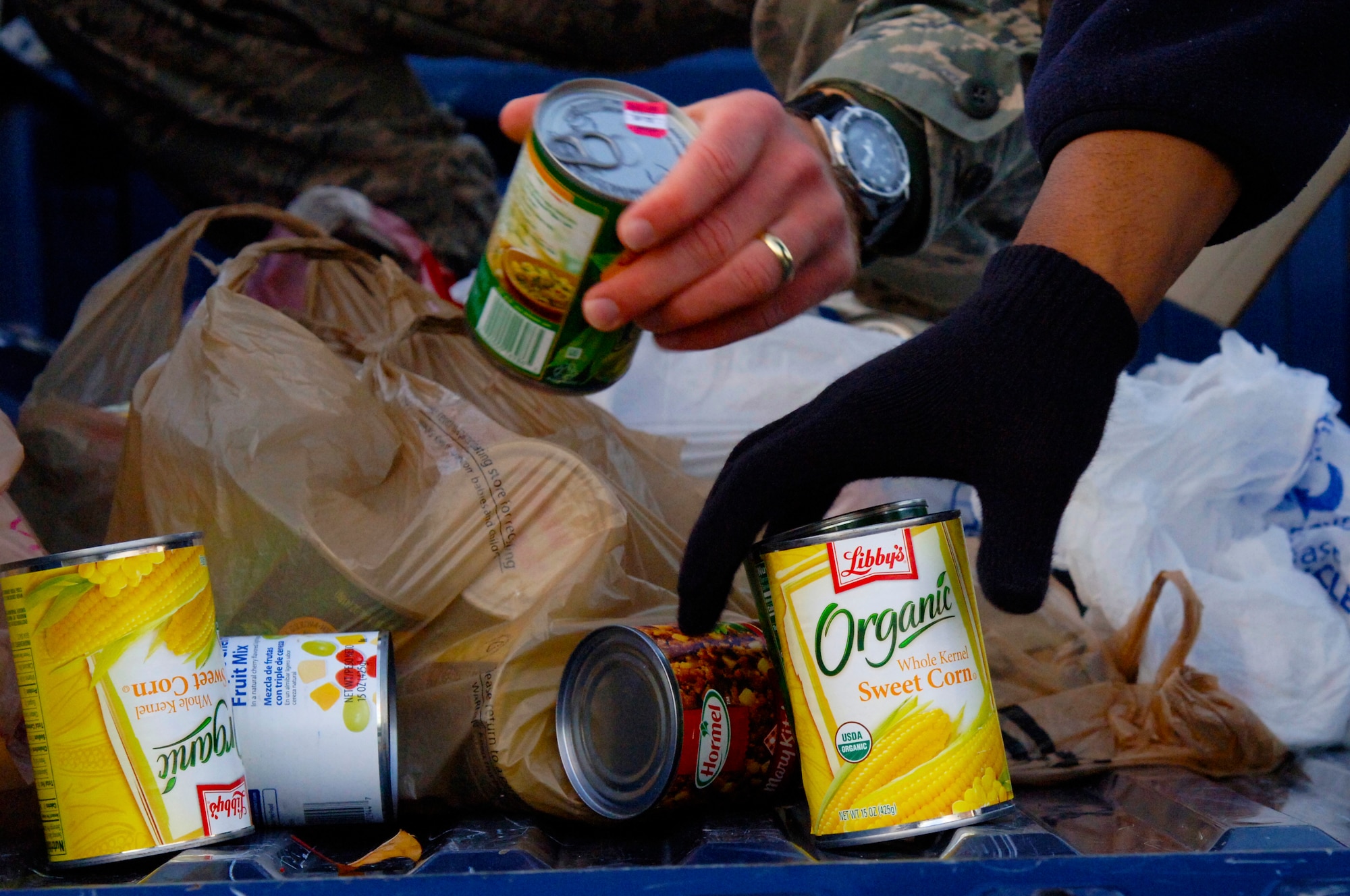 U.S. Air Force Master Sgt. Brian Lackman, Air Force Targeting Center first sergeant, and Master Sgt. James Mitchell, 10th Intelligence Squadron First Sergeant, stack food cans donated by Langley First Sergeants Council 5K Fun Run Walk participants to benefit Operation Warmheart, at Langley Air Force Base, Va., Nov. 16, 2012. Operation Warmheart is the single largest community and outreach program for Langley.(U.S. Air Force photo by Airman 1st Class Victoria Taylor/Released)