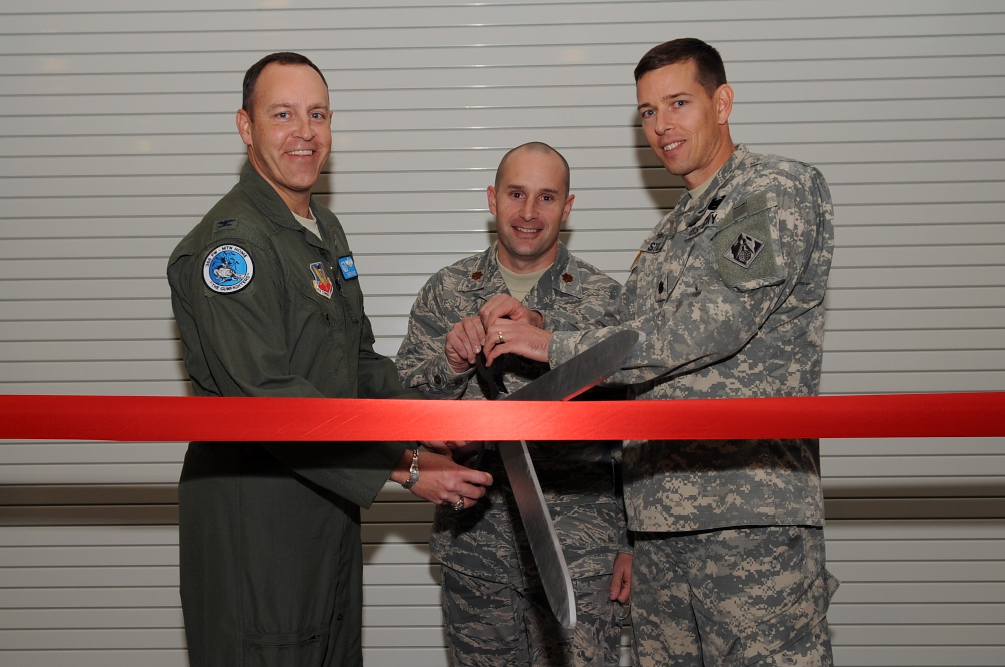 U.S. Air Force Col. Chris Short, 366th Fighter Wing commander, Maj. Todd Jensen, 366th Logistics Readiness Squadron commander, and U.S. Army Lt. Col. Kevin Stoll, U.S. Army Corps of Engineers, Seattle District deputy commander, kick off the grand opening of the Logistics Readiness Center Nov. 15, here, during a ribbon cutting ceremony. The LRC is the new hub of activity for more than 350 logistic professionals. (U.S. Air Force photo/Staff Sgt. Roy Lynch)
