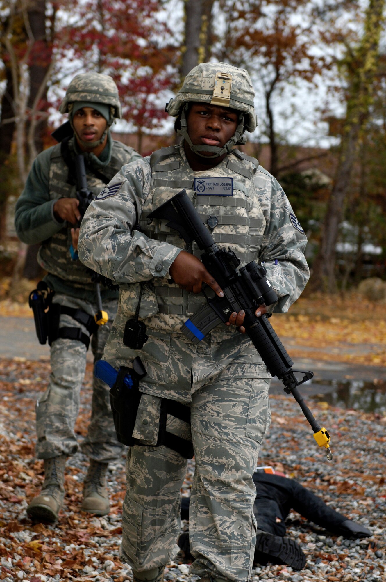 U.S. Air Force Staff Sgt. Bethani Joseph, 633rd Security Forces Squadron patrolman, is followed by Staff Sgt. Ervin Faison, 633rd SFS member, during a simulated-active shooter exercise at Langley Air Force Base, Va., Nov. 15, 2012. Joseph and Faison were part of the first responder team for security forces. (U.S. Air Force photo by Airman Kimberly Nagle/Released)