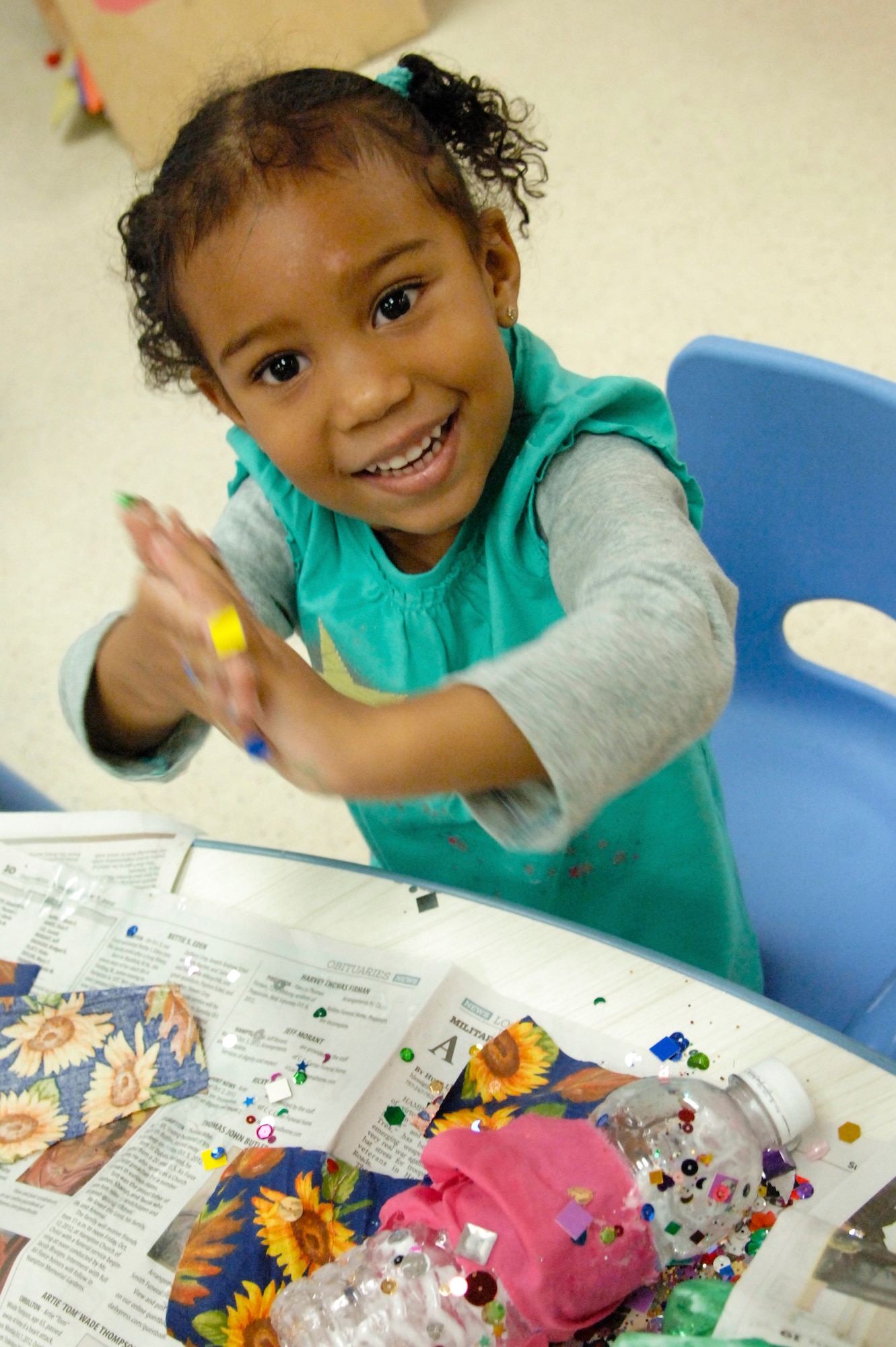 Sanaa Dingle, daughter of Tech. Sgt. Karla Guevara, 438 Supply Chain Operations Squadron F-16 mission capable parts superintendent, wipes her hands clean after finishing her recyclable-zebra project during an America Recycles Day event at Langley Air Force Base, Va., Nov. 15, 2012. Every year America Recycles Day organizes thousands of different events around the country to educate neighbors, friends, children and colleagues. (U.S. Air Force photo by Airman 1st Class Victoria Taylor/Released)