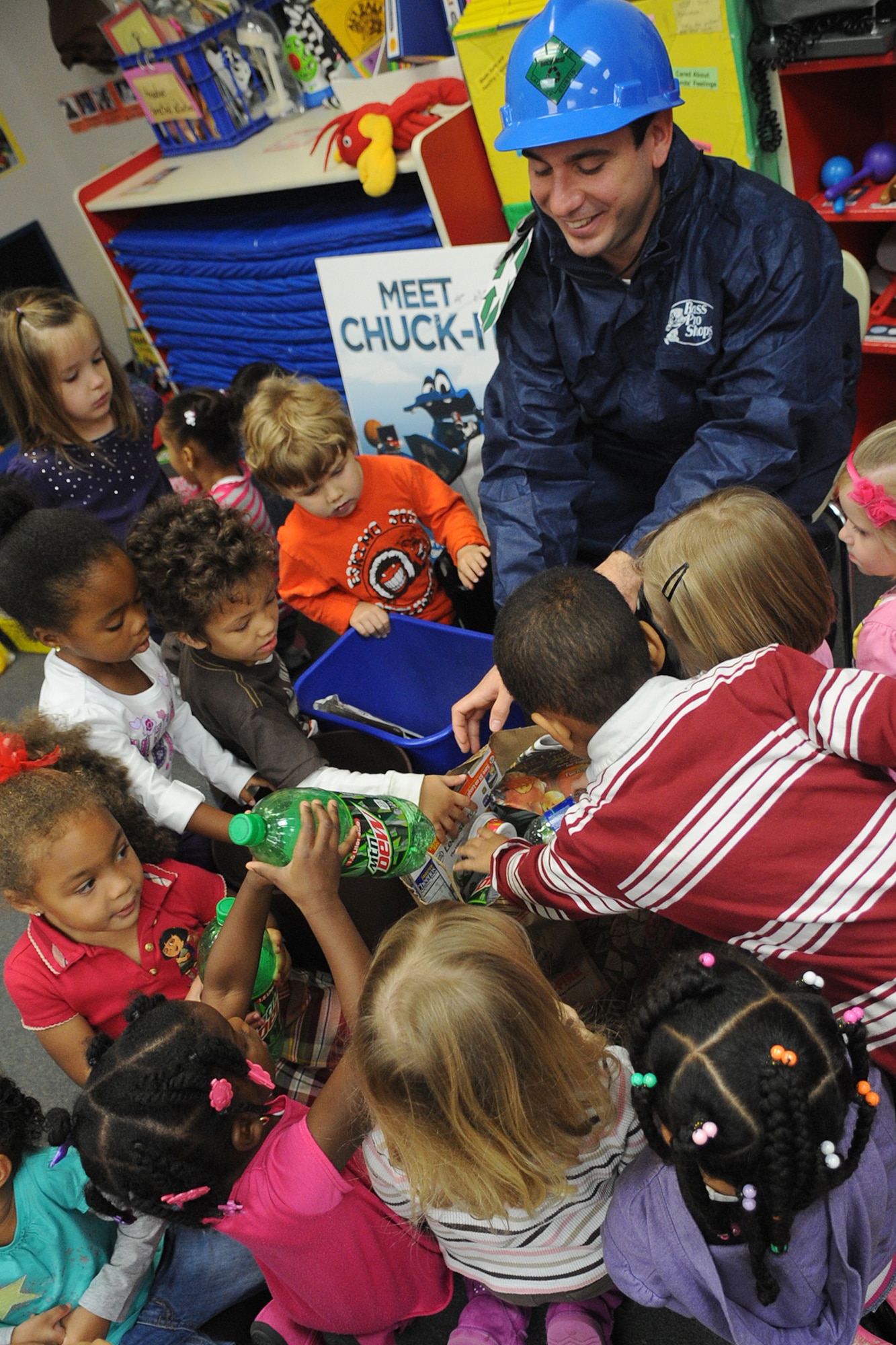 Children from the Russ Child Development Center pick recyclable items from Michael Mallozzi’s, (right) 633rd Civil Engineering Squadron pollution preventative manager, bag during an America Recycles Day event at Langley Air Force Base, Va., Nov. 15, 2012. America Recycles Day is a day to educate, motivate, learn about the community’s recycling options and reduce personal waste. (U.S. Air Force photo by Senior Airman Racheal E. Watson/Released)