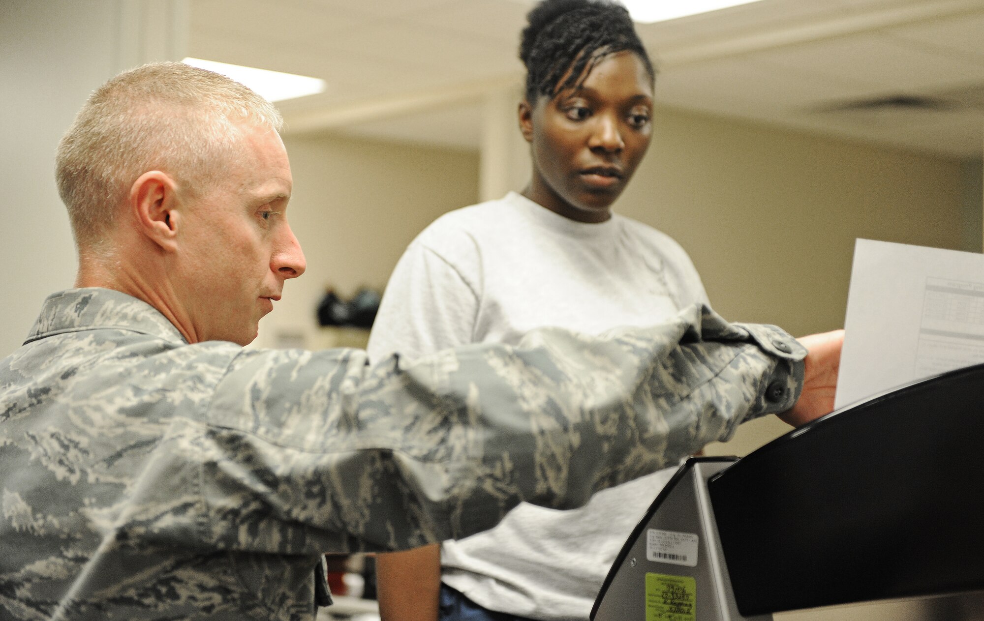 Maj. Jon Ehrenfried, 375th Medical Operations Squadron physical therapy and chiropractic flight commander, explains exercises to a patient Nov. 13 at Scott Air Force Base, Ill. The physical therapy clinic houses a wide variety of equipment for patients to use in order to rehabilitate their injuries. (U.S. Air Force photo/Airman Kris Lynch)