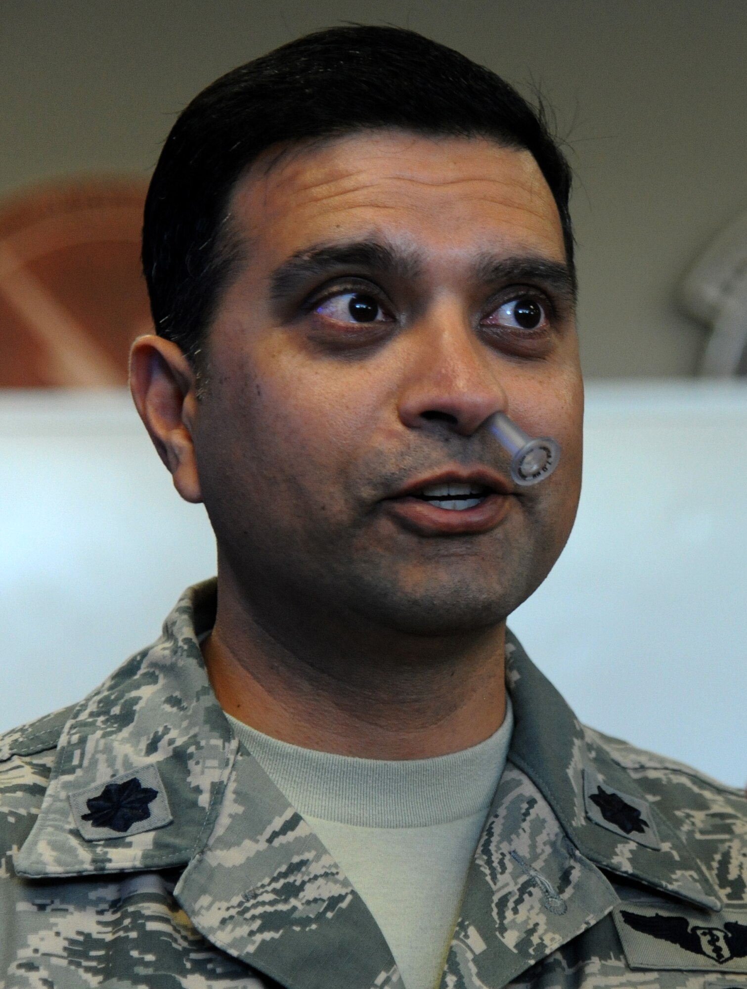 Lt. Col. Chetan Kharod, 24th Special Operations Squadron surgeon, speaks during the Tactical Combat Casualty Care course with little discomfort after he inserted a nasopharyngeal airway on himself Nov. 9, 2012 at Hurlburt Field, Fla. The underlying intent of the course is to provide hands-on skills in tourniquet application, needle thoracotomy, airway management, pain control, and fracture management. (U.S. Air Force photo by Senior Airman Melanie Holochwost)  