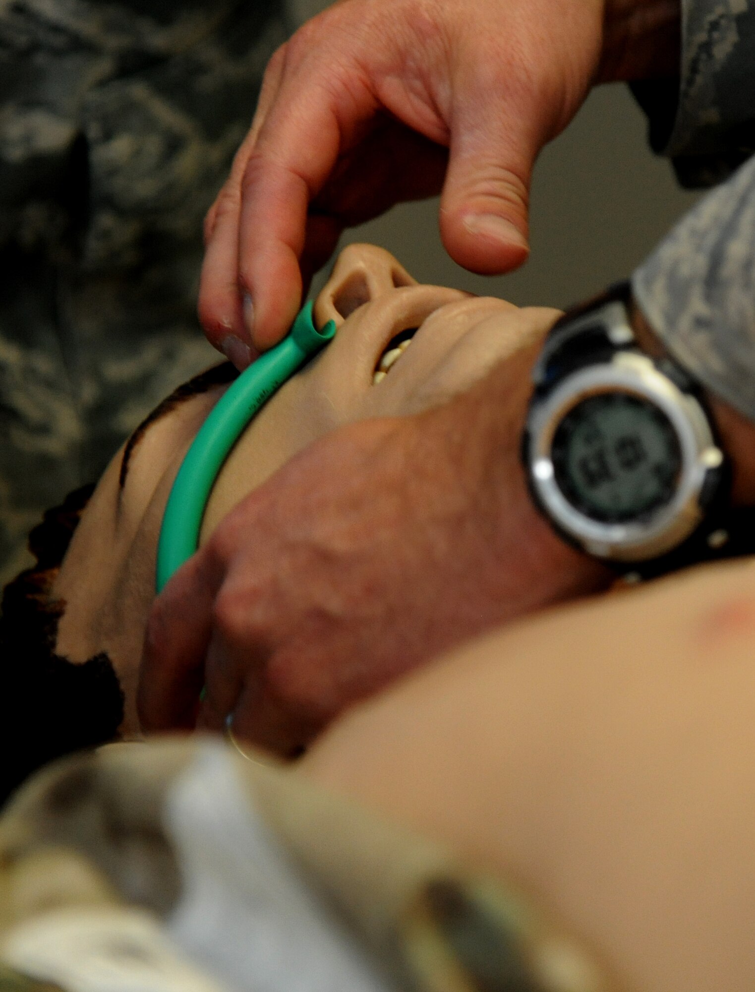 A Tactical Combat Casualty Care student measures wear to cut the nasopharyngeal airway tube on a dummy during a Tactical Combat Casualty Care course Nov. 9, 2012 at Hurlburt Field, Fla. The length of the tube should be measured from the side of the nose to the ear. (U.S. Air Force photo by Senior Airman Melanie Holochwost)  
