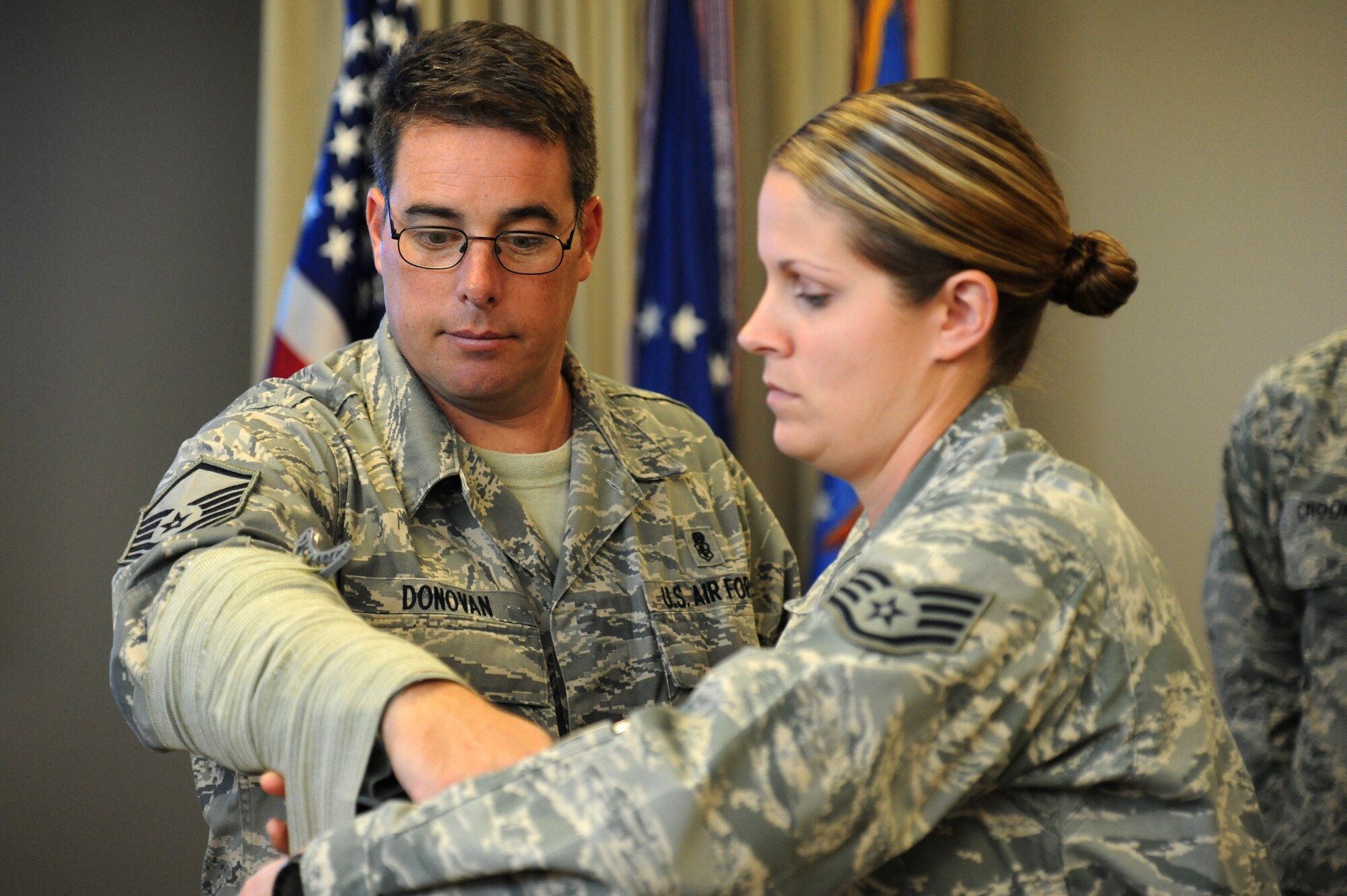 Master Sgt. Eric Donovan and Staff Sgt. Sara Windsor, 24th Special Operations Squadron medics, demonstrate  how to splint a broken bone during a Tactical Combat Casualty Care course Nov. 9, 2012 at Hurlburt Field, Fla. TCCC is taught to give a person a chance to survive a combat injury until definitive medical care is given. The course focuses not only on what to do in these situations, but more importantly, when to do it. (U.S. Air Force photo by Senior Airman Melanie Holochwost)  