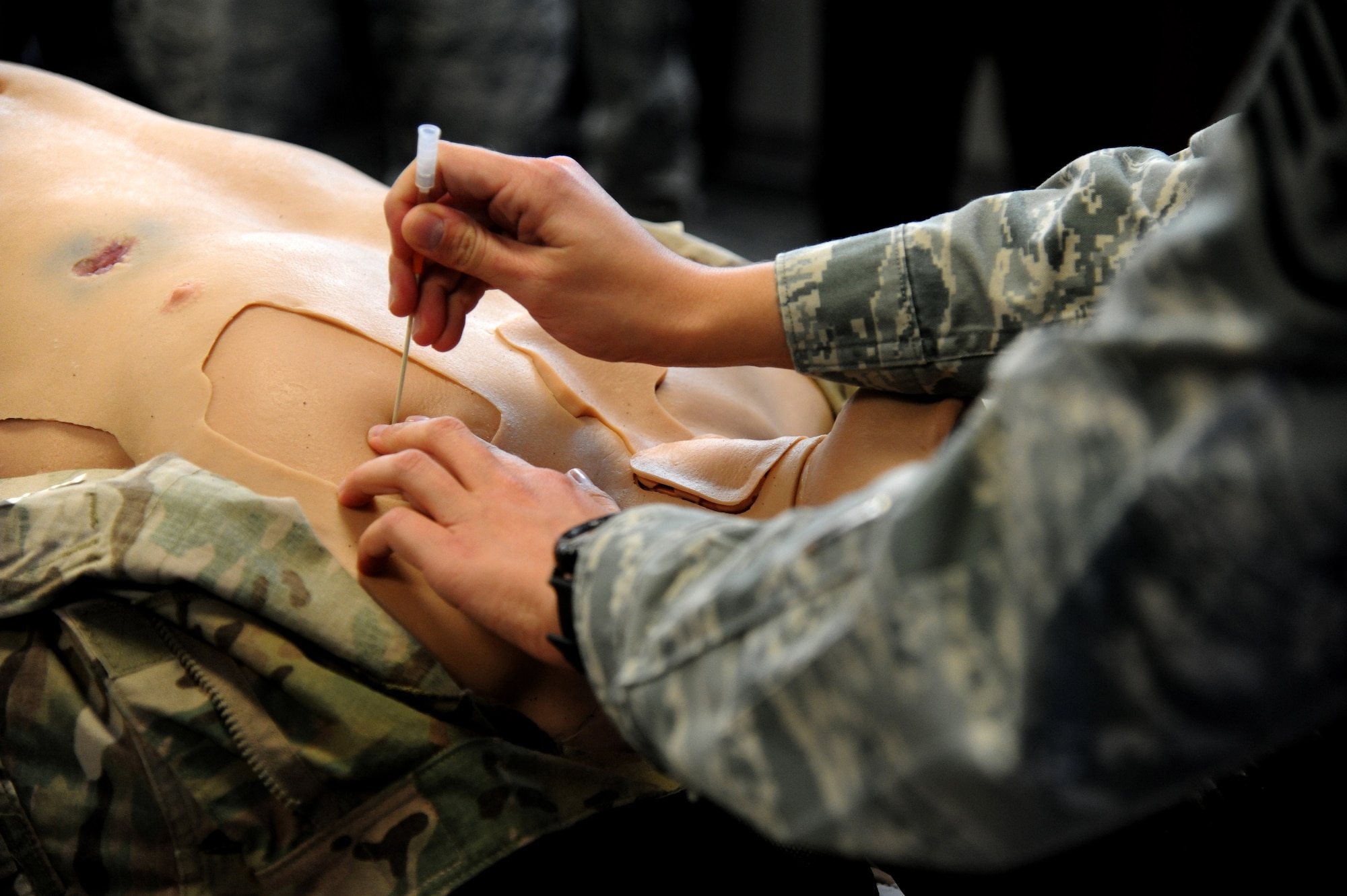 A Tactical Combat Casualty Care student inserts a catheter into a dummy’s chest during a Tactical Combat Casualty Care course Nov. 9, 2012 at Hurlburt Field, Fla.  According to Master Sgt. Eric Donovan, 24th Special Operations Squadron medic, this procedure should be done when a person’s chest has been compromised due to a blunt trauma, gunshot wound, or a blast causing injury to the lung. (U.S. Air Force photo by Senior Airman Melanie Holochwost)  