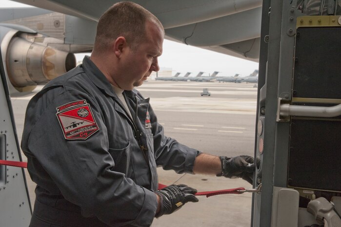 Tech. Sgt. Joshua Drakos, 437th Aircraft Maintenance Squadron crew chief, performs a preventative maintenance check on a C-17 doorway Nov. 14, 2012, at Joint Base Charleston - Air Base, S.C. Drakos was awarded the identifier of Dedicated Crew Chief during a ceremony in June 2012.  A DCC is typically a senior-experienced crew chief who is assigned to one particular aircraft, but assists and mentors other crew chiefs on the flightline. (U.S. Air Force photo/Tech. Sgt. Vernon Cunningham)