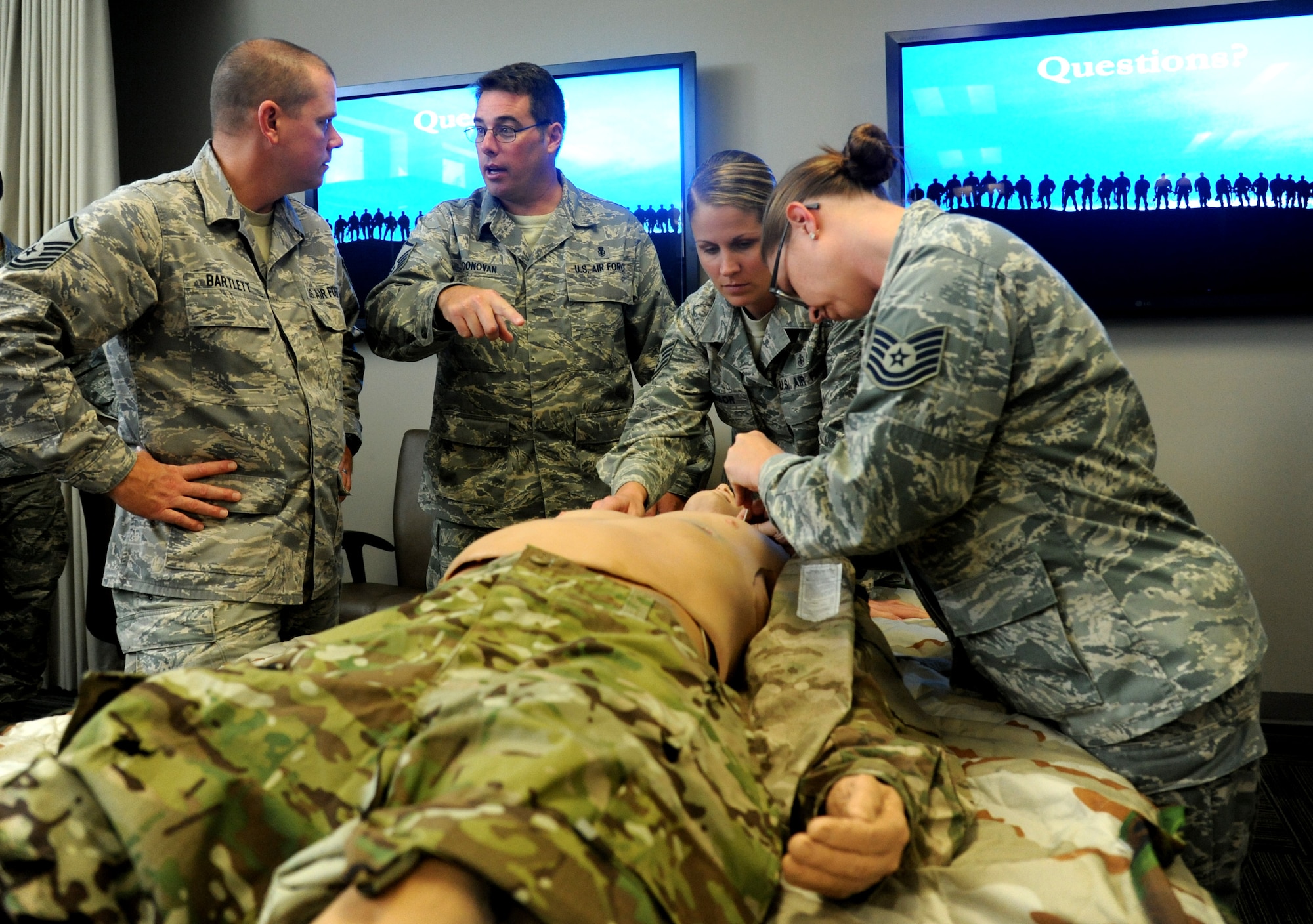 Master Sgt. Eric Donovan and Staff Sgt. Sara Windsor, 24th Special Operations Squadron medics, instruct Tactical Combat Casualty Care students how to perform needle decompression on a dummy Nov. 9, 2012 at Hurlburt Field, Fla. The course focused on combat scenarios that special operators are likely to face downrange. (U.S. Air Force photo by Senior Airman Melanie Holochwost)  