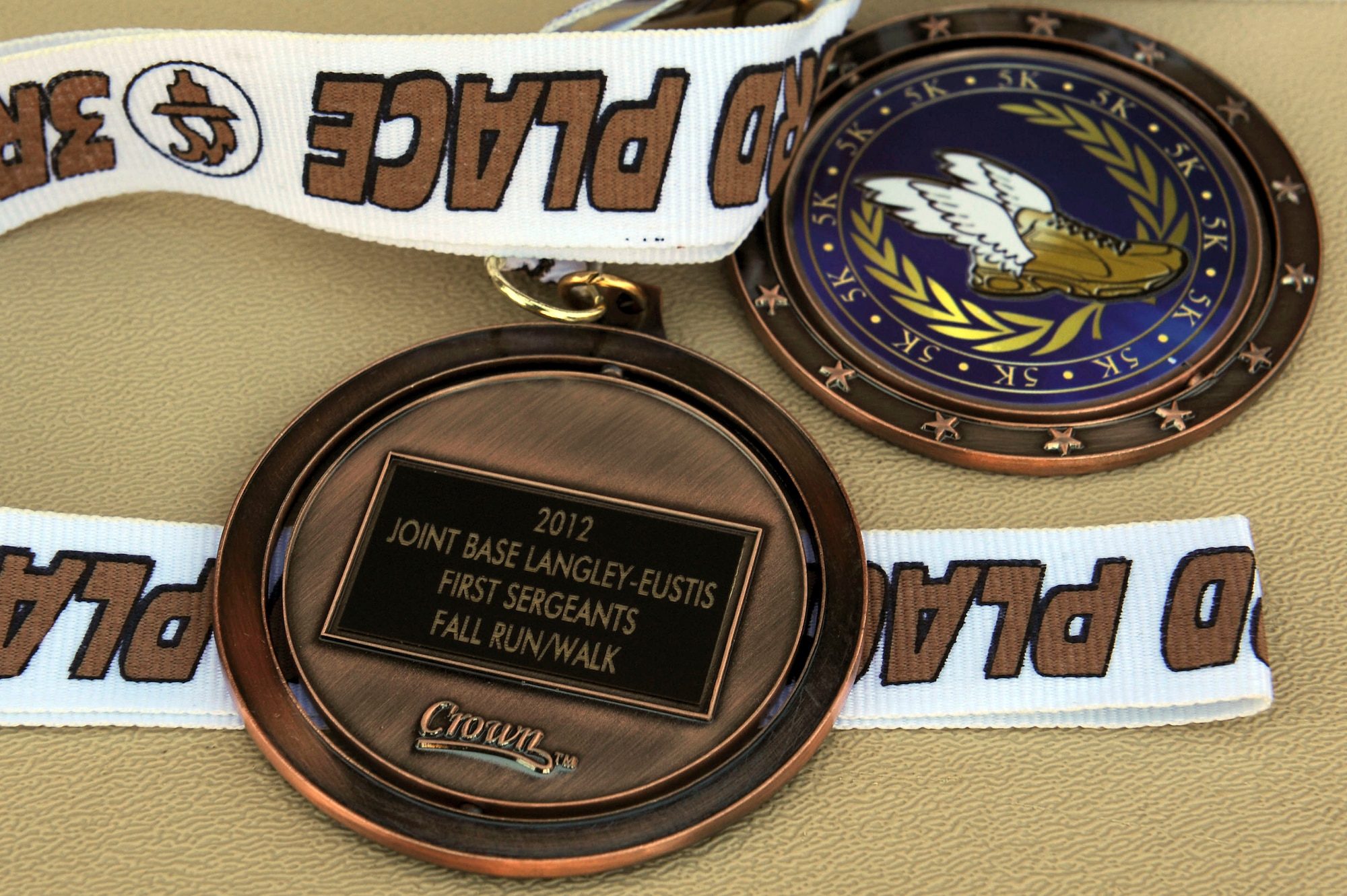 Participants who finish first, second and third place at the Langley First Sergeants’ Council 5k run or walk receive a medal at Langley Air Force Base, Va., Nov. 16, 2012. The 5k raised money and collected canned food items for Operation Warmheart, a community and outreach program for Langley Airmen that provides year-round assistance. (U.S. Air Force photo by Staff Sgt. Ciara Wymbs)   