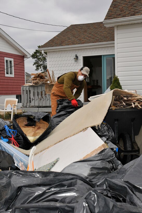 Dan Marren and his wife, Kristi (not pictured), help remove debris from a friend’s house just days after Super Storm Sandy made its way past Tunnel 9 in Maryland and moved up the coast.

