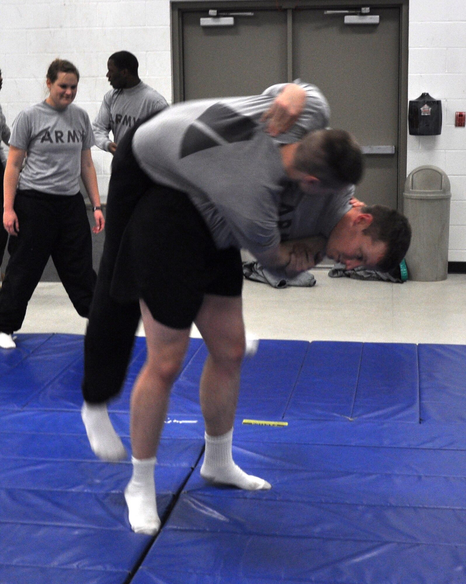 GOODFELLOW AIR FORCE BASE, Texas – Army Sgt. James Reed, Army 344th Military Intelligence Battalion student, flips Army Pfc. Jared Nistler, Army 344th Military Intelligence Battalion student, as they practice grappling at the Mathis Fitness Center here Nov. 14. Reed gave lessons to other military members during Wingman Day. (U.S. Air Force photo/ Airman 1st Class Joshua Edwards)
