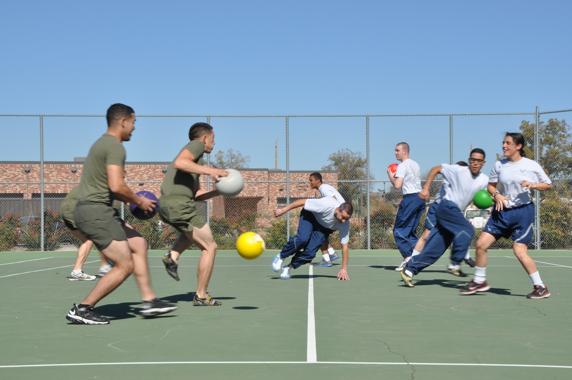 GOODFELLOW AIR FORCE BASE, Texas – Marines Corps Detachment members play against 316th Training Squadron members in dodge ball for Wingman Day at one of the tennis courts near the Mathis Fitness Center here Nov. 14. The Marines won this game and continued onto the second round. (U.S. Air Force photo/ Airman 1st Class Joshua Edwards)
