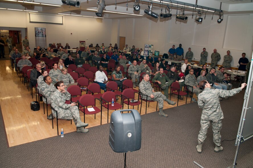 Lieutenant Col. Caryn Kirkpatrick gives a briefing to members of Holloman Air Force Base, N.M., during a town hall meeting at the Community Activity Center Nov. 15. Residents attended the town hall meeting to give feedback to the commander and learn about the newest plans for the base. (U.S. Air Force photo by Airman 1st Class Daniel E. Liddicoet/Released)