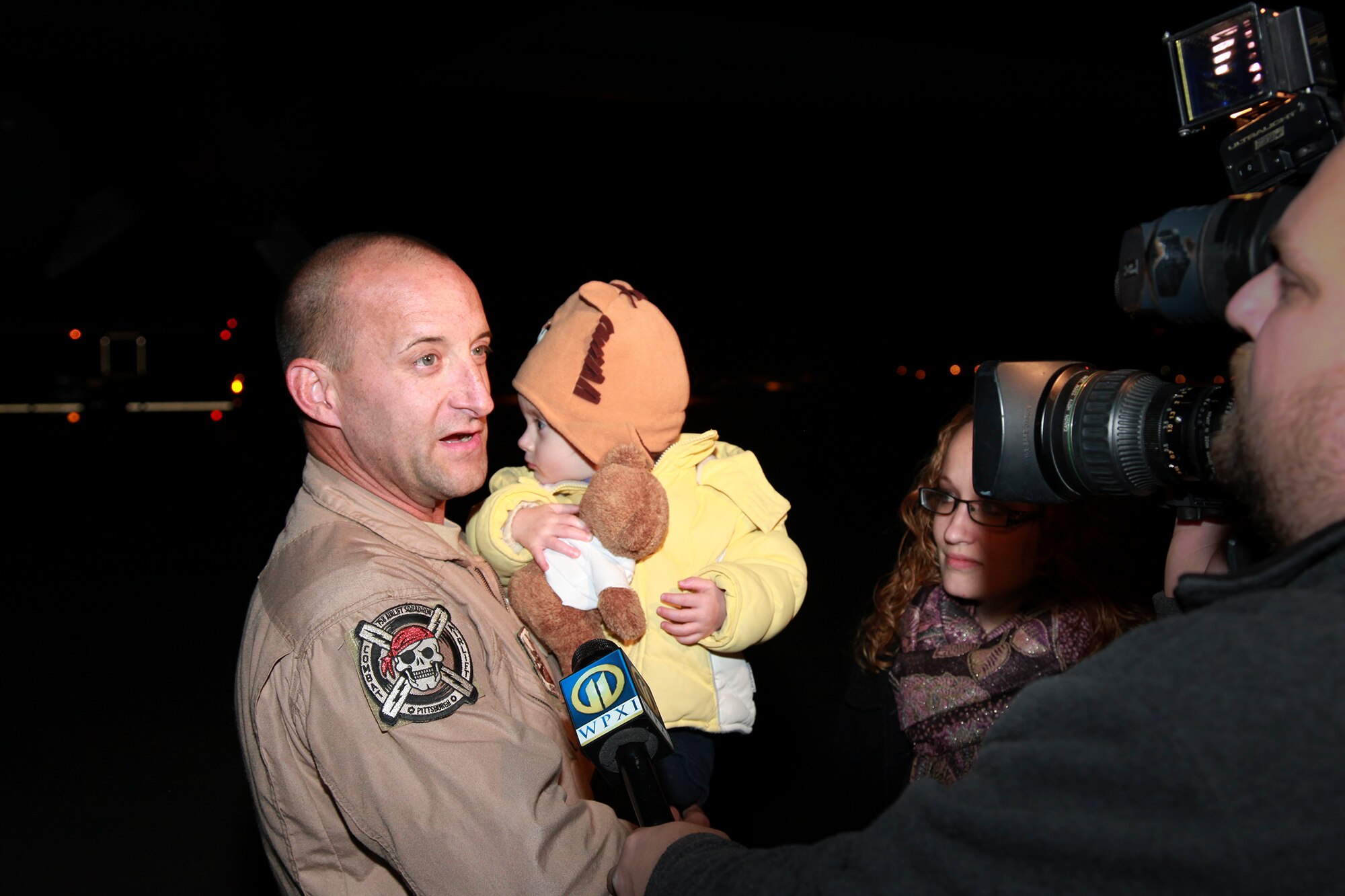 Tech. Sgt. Rich Newhouse, a 911th Airlift Wing loadmaster, expresses his enthusiasm to a WPXI Channel 11 news reporter here, Nov. 15, 2012 after reuniting with his family. Newhouse and 14 other Airmen returned home after a 60-day deployment in support of operations within the U.S. Central Command area of operations.  Nearly 100 members of the 911 AW are still deployed in support of this Air Expeditionary Force rotation with an expected return sometime after the New Year. (U.S. Air Force photo by Tech. Sgt. Ralph Van Houtem/Released)