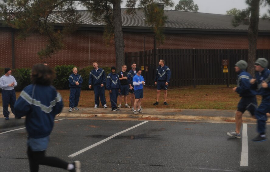 Members of Team Moody cheer on Airmen as they reach the finish line during the Turkey Chase 5K at Moody Air Force Base, Ga., Nov. 16, 2012. Approximately 250 people participated in the event. (U.S. Air Force photo by Airman 1st Class Olivia Bumpers/Released)