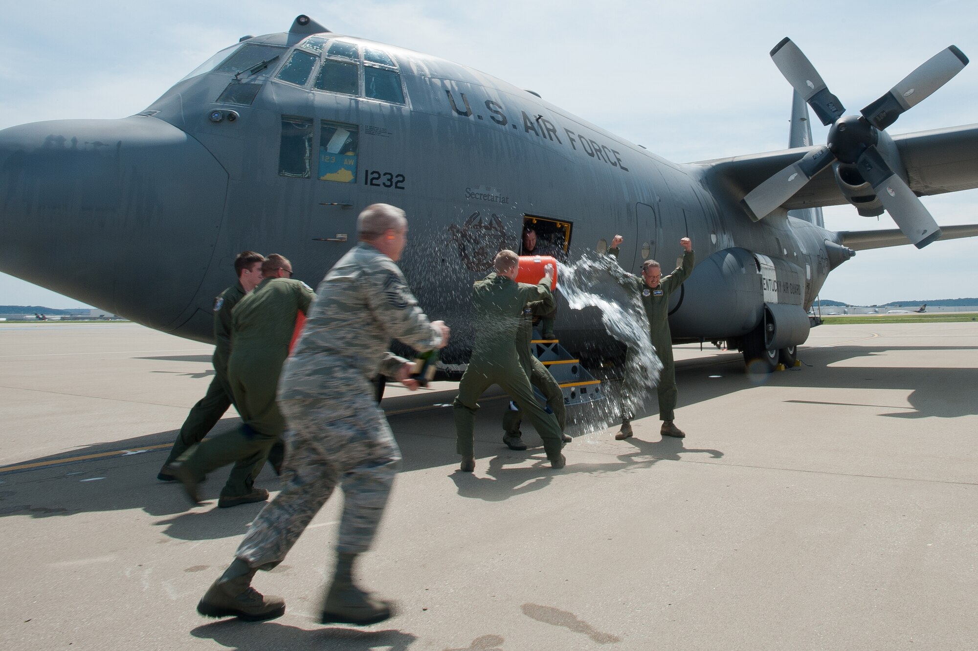 Members of the 123rd Airlift Wing douse Col. Greg Nelson with water and champagne on the flight line of Kentucky Air National Guard Base in Louisville, Ky., Aug. 12, 2012, after Nelson completes his final flight as wing commander. Nelson has been named deputy director of strategic plans and policy at the National Guard Bureau in Washington, D.C., where he will serve as a brigadier general. Piloting Nelson's "fini flight" was Col. Warren Hurst, who will replace Nelson as commander of the 123rd. (U.S. Air Force photo by Maj. Dale Greer)
