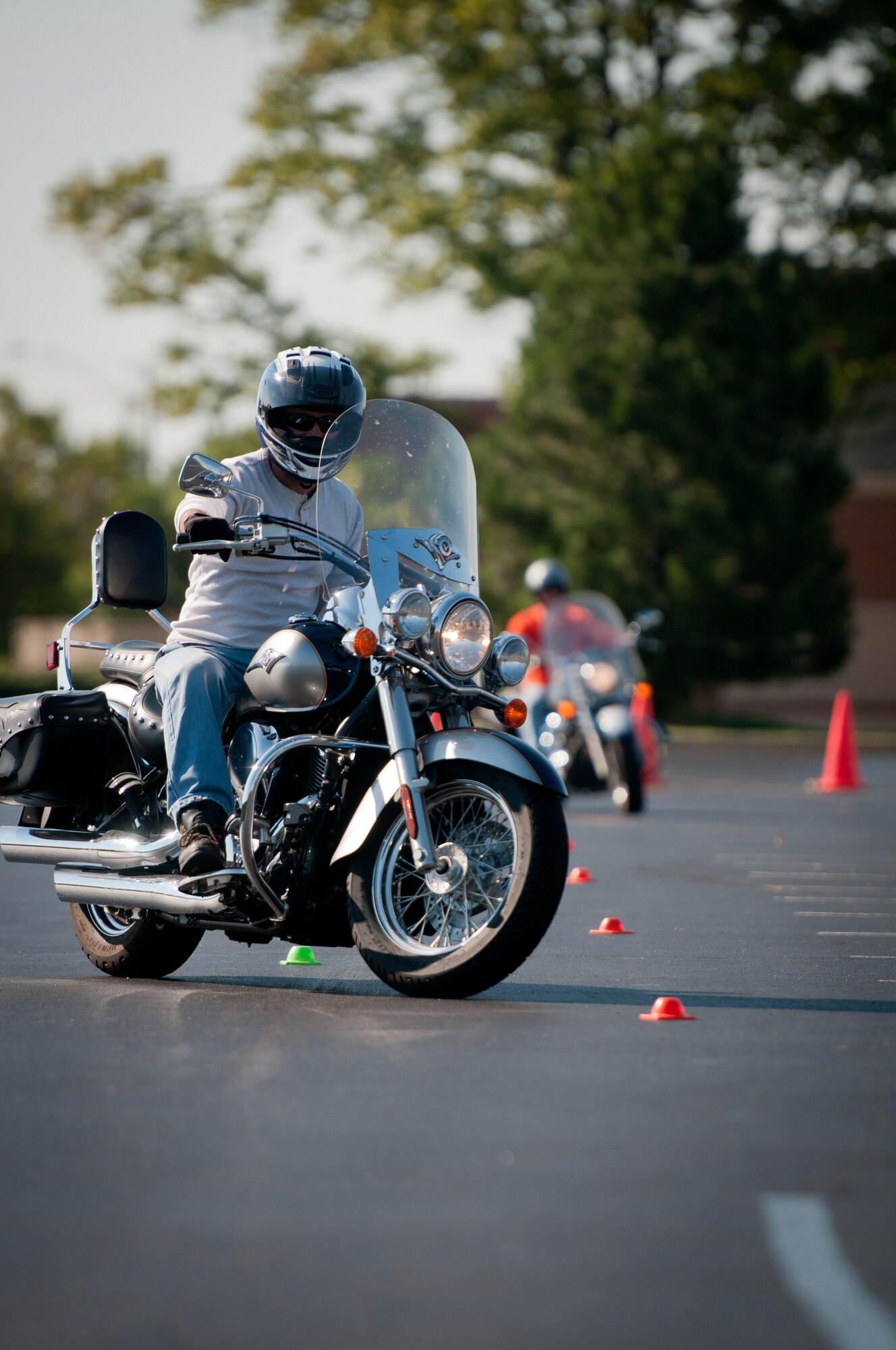 Kentucky Air National Guard Lt. Col. Armand Bolotte, 123rd Logistics Readiness Squadron operations officer, weaves in out of cones during a motorcycle safety train-the-trainer course at the Kentucky Air National Guard Base in Louisville, Ky., on Aug. 23, 2012. The course, part of the Motorcycle Safety Foundation's RiderCoach Program, was designed in part to train student instructors so they can go on to teach motorcycle safety to other service members. (Kentucky Air National Guard photo by Master Sgt. Phil Speck)