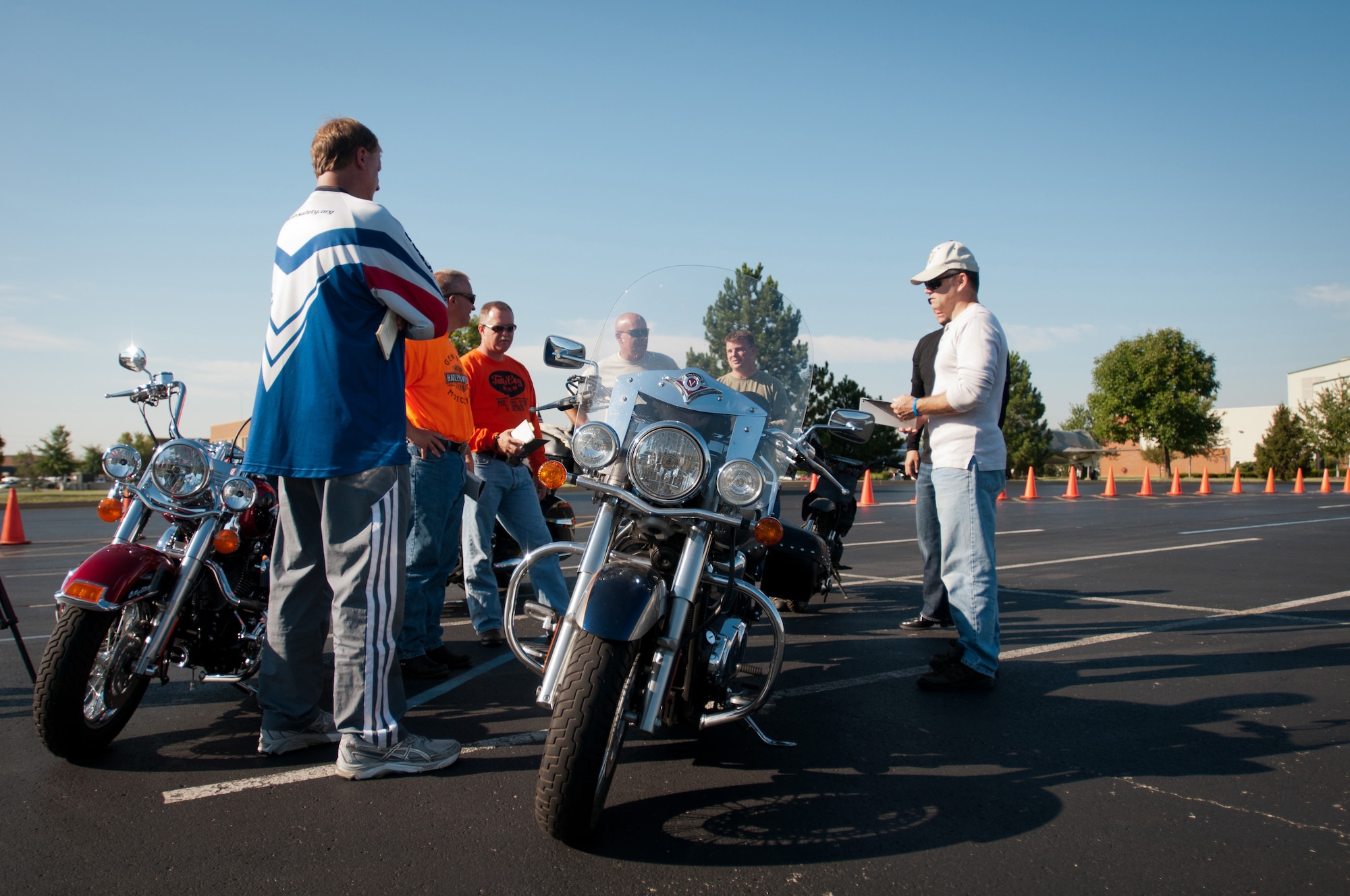Kentucky Air National Guard members talk about the next exercise during a motorcycle safety train-the-trainer course at the Kentucky Air National Guard Base in Louisville, Ky., on Aug. 23, 2012. The course, part of the Motorcycle Safety Foundation's RiderCoach Program, was designed in part to train student instructors so they can go on to teach motorcycle safety to other service members. (Kentucky Air National Guard photo by Master Sgt. Phil Speck)