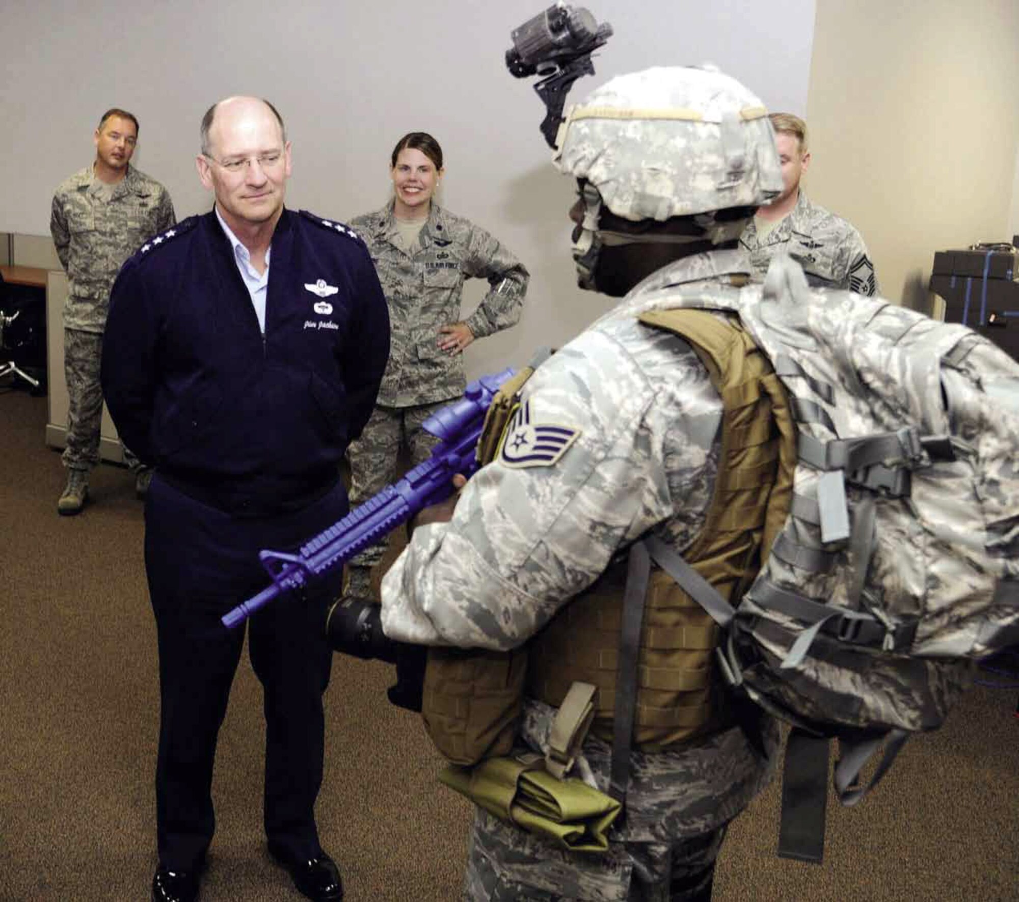 Staff Sgt. Dayton Mitchell, 4th Combat Camera Squadron, profiles the gear that camera operators use during overseas deployments, to Lt. Gen. James Jackson, chief, Air Force Reserve, Headquarters, U.S. Air Force and commander, Air Force Reserve Command. Lt. Gen. Jackson visited March Field, Nov. 8, as part of a series of tours arranged to give him an inside look at the missions of the units that operate under his command. (U.S. Air Force photo by Tech. Sgt. Samara Scott)
