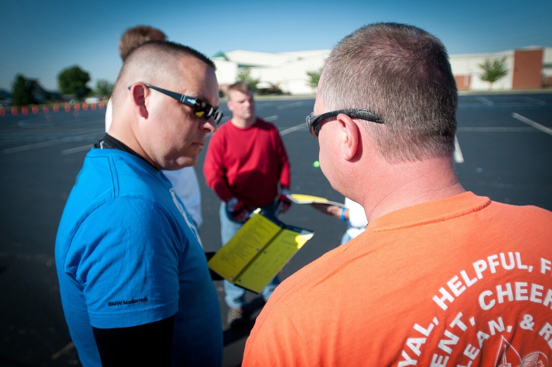 Kentucky Air National Guard Maj. Todd Franks, a C-130 Hercules pilot with the 165th Airlift Squadron, discusses basic motorcycle maneuvers with a fellow student during a motorcycle safety train-the-trainer course at the Kentucky Air National Guard Base in Louisville, Ky., on Aug. 22, 2012. The course, part of the Motorcycle Safety Foundation's RiderCoach Program, was designed in part to train student instructors so they can go on to teach motorcycle safety to other service members. (Kentucky Air National Guard photo by Master Sgt. Phil Speck)