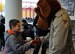 Sean Hogan, 10, son of Master Sgt. Chris Hogan, 86th Security Forces flight chief, shakes hands with the security forces mascot, Scruffy, at a neighborhood watch outreach booth, Ramstein Air Base, Germany, Nov. 16, 2012. The Neighborhood Watch program is just one of many services offered by security forces and the Air Force Office of Special Investigations to ensure the safety of the community. (U.S. Air Force photo/Airman 1st Class Trevor Rhynes)