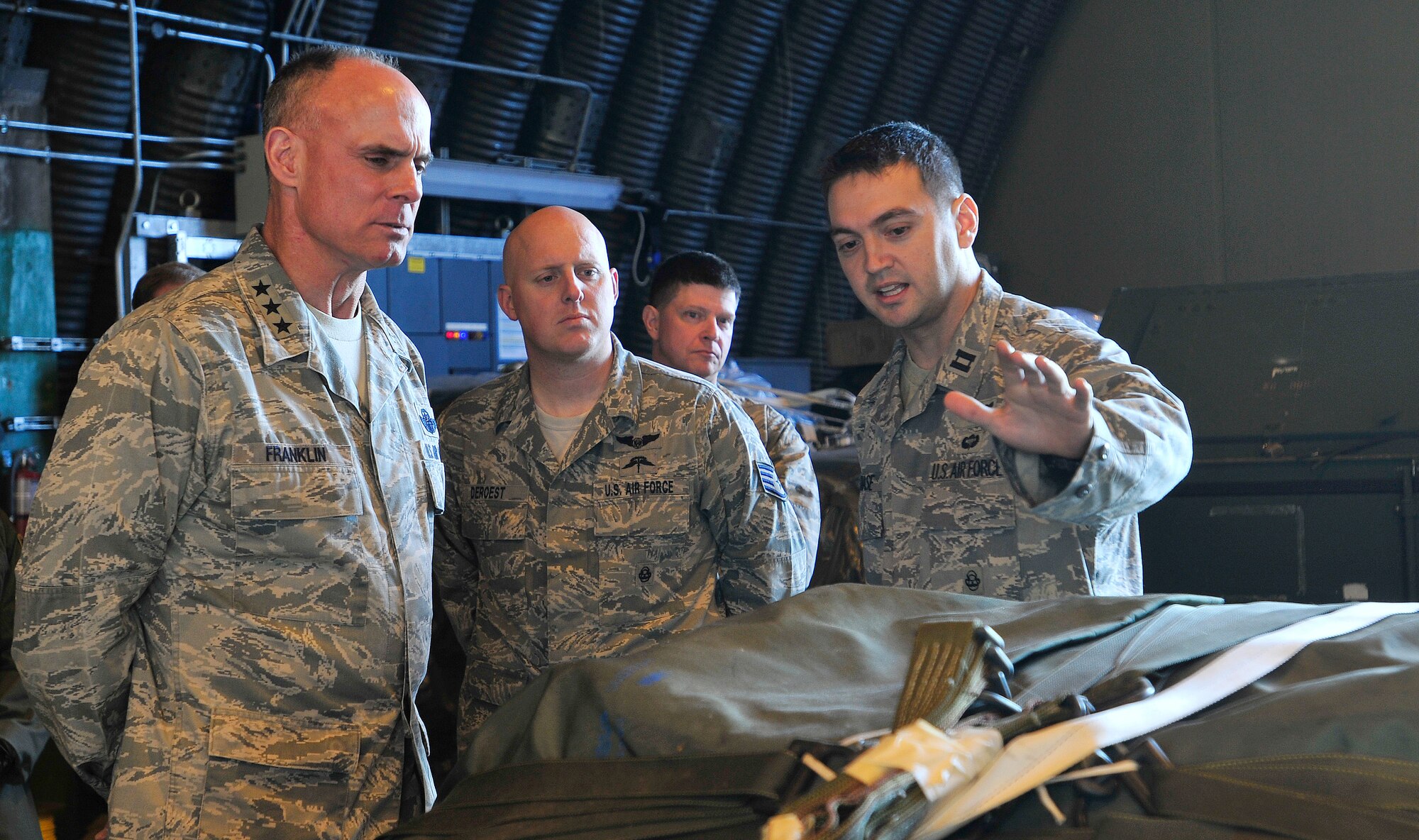 ROYAL AIR FORCE LAKENHEATH, England – Capt. William Chase (right), 56th Rescue Squadron flight commander, explains the mission of the 56th RQS, shows the gear they use to accomplish the mission and highlights their need for supporting assets to Lt. Gen. Craig Franklin, 3rd Air Force commander, Nov. 14, 2012. Franklin visited RAF Lakenheath as part of his immersion since becoming the 3rd AF commander in March. He visited the hospital, IDRC, Hangars 6 and 7, fire department, 56th Rescue Squadron and other areas around the base to familiarize himself with the 48th Fighter Wing members and mission. (U.S. Air Force photo by Senior Airman Tiffany M. Grigg) 