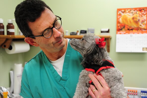 Andrew Bradley, a veterinarian at the Maxwell Air Force Base veterinarian clinic, performs a routine checkup Thursday. Maxwell's vet clinic offers routine vaccinations, microchips, health certificates and also carries various animal care products. The vet clinic also performs minor skin, ear, eye exams, and routine tests. It is located in Bldg 914 on Arnold Street next to the Airman's Attic. Animals are seen by appointment only. Normal hours of operation are Monday-Friday, 8:00 a.m. to 4:00 p.m. For more information or to schedule an appointment, call 953-7357. (U.S. Air Force photo by Senior Airman Christopher Stoltz)