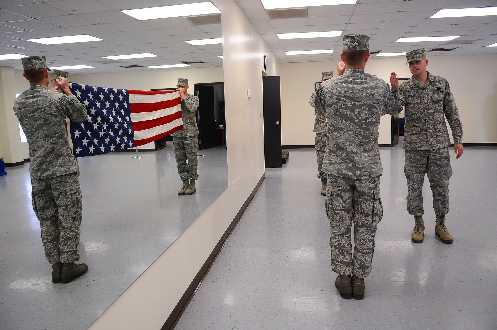 U.S. Air Force Airmen from the Shaw Air Force Base honor guard practice folding a flag at Shaw Air Force Base, S.C., Nov. 14, 2012. Every three months, Airmen at Shaw volunteer or are selected by their squadron to be a part of the base honor guard. Their honor guard service lasts up to a year with three month rotations. (U.S. Air Force photo by Airman Nicole Sikorski/Released)