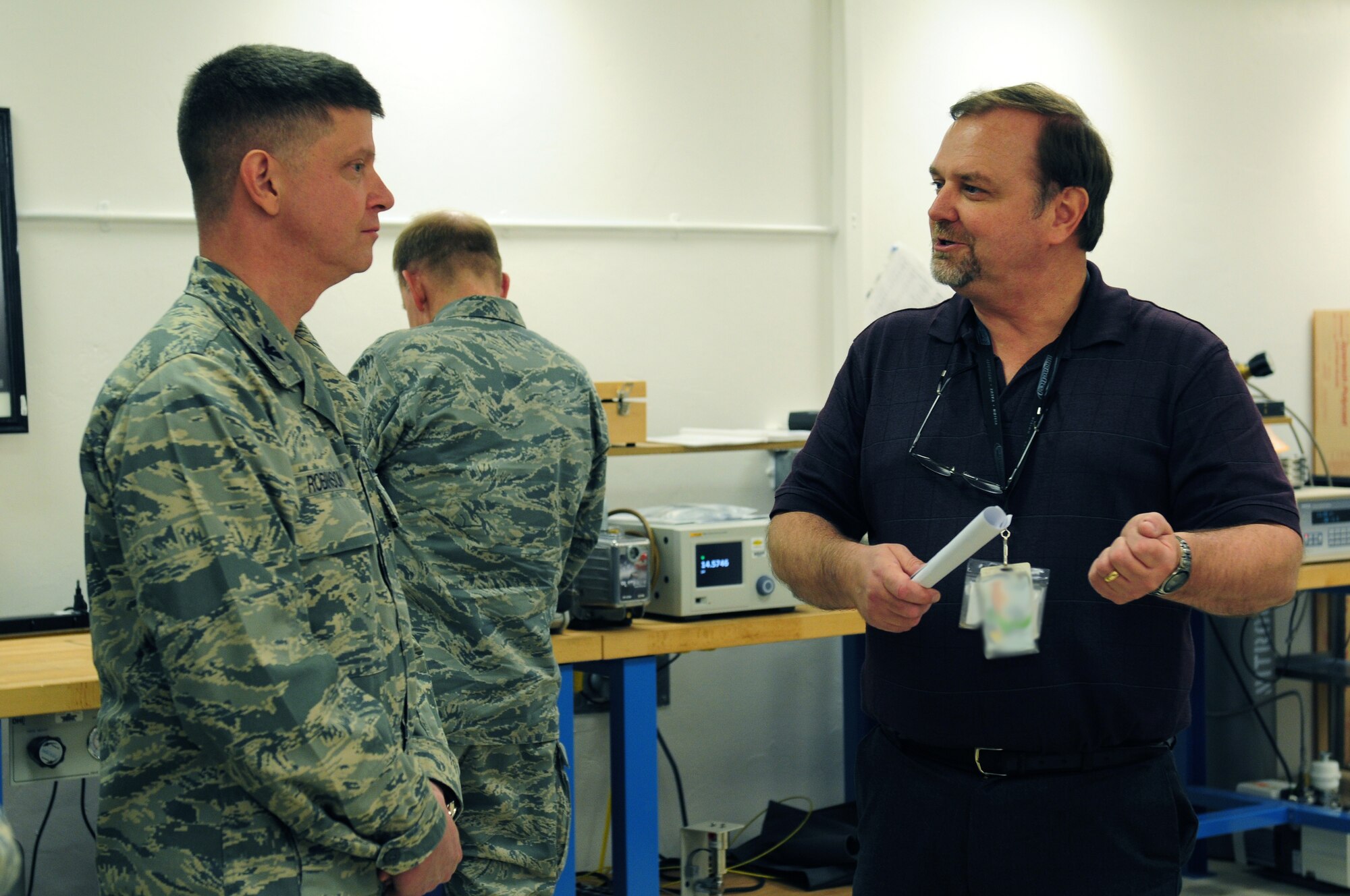 ROYAL AIR FORCE LAKENHEATH, England – Col. Kyle W. Robinson, 48th Fighter Wing commander, speaks with Mark Pridgen, 48th Component Maintenance Squadron Precision Measurement Equipment Laboratory Bionetics site manger, during a tour Nov. 9, 2012. Wing leadership visited the birds of prey and PMEL to familiarize themselves with contractors hired by RAF Lakenheath. (U.S. Air Force photo by Airman 1st Cory D. Payne)