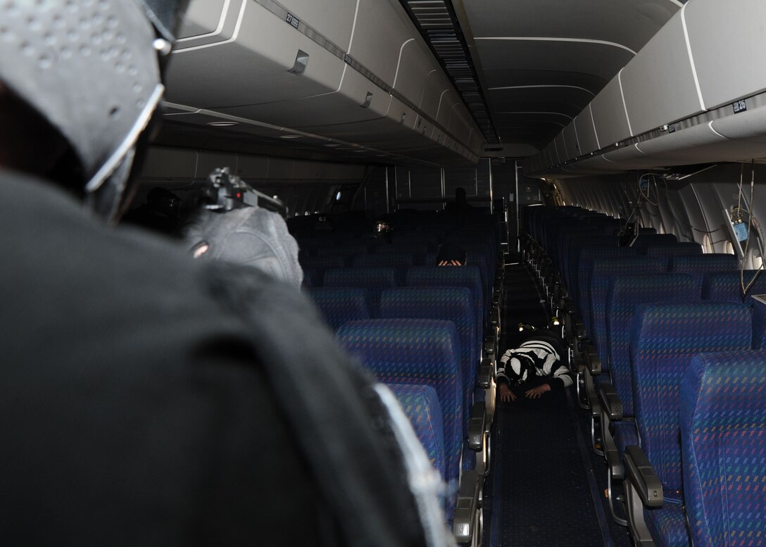 An Emergency Services Team member takes down a mock hijacker during an anti-high jacking exercise Nov. 9, 2012 at the Joint Training Facility at Baltimore Washington International Airport, Md. The exercise was a joint effort between the Andrews EST and the Raven team where they practiced tubular assaults during a mock hijacking scenario. (U.S. Air Force photo/ Senior Airman Bahja J. Jones)